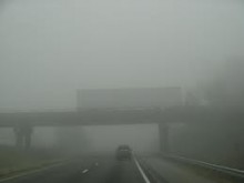 Transport truck crossing a overpass in heavy fog